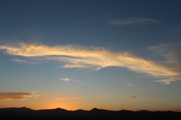 Obraz premium Heavens illuminate as sun sets over the Hexie Mountains of Joshua Tree National Park. Although much of the range is within the Mojave, its edges transition and integrate with the Colorado Desert.