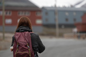 Girl walking through Longyearbyen - Svalbard . Norway