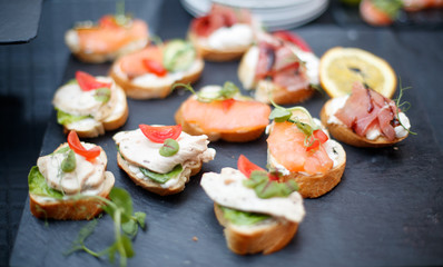 Beautifully decorated catering banquet table with different food snacks and appetizers.