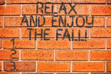 Conceptual hand writing showing Relax And Enjoy The Fall. Business photo showcasing Enjoying the autumn season beautiful falling leaves