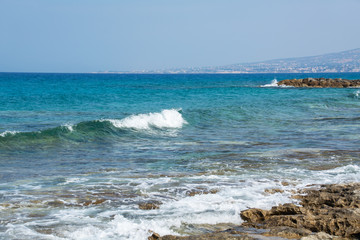 Seascape of the Mediterranean Sea with waves of the turquoise sea on the volcanic coast of Cyprus