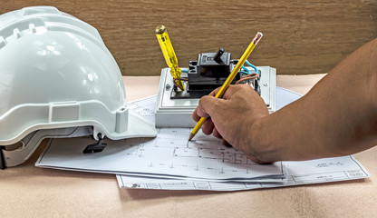 Engineers are drawing the electrical construction in the office.