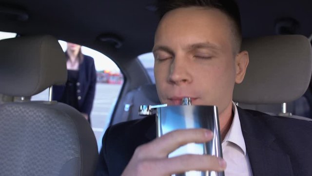 Driver drinking alcohol while waiting client, dangerous addiction, law violation