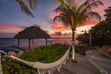 Sunset over the sea from a house and swimming pool