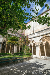 Fototapeta na wymiar Courtyard with columns and arches in old Dominican monastery in Dubrovnik, Croatia