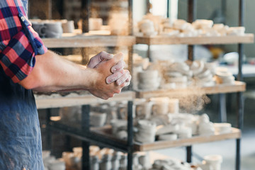 Middle age male hands clapping hands with powder.