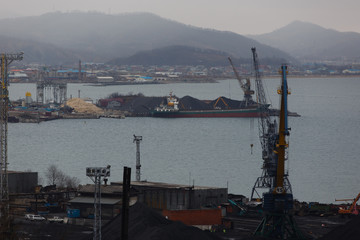 Coal terminal in the sea trading port of the sea city of Nakhodka. Coal collapse on the coast of a...