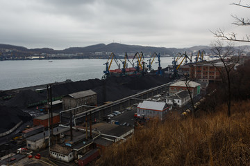 Coal terminal in the sea trading port of the sea city of Nakhodka. Coal collapse on the coast of a...
