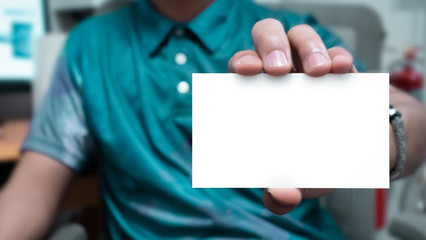 Man holding a blank white small card. -Template for business card or some other information.