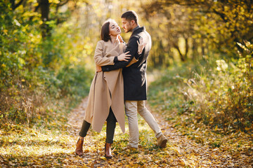 Fototapeta premium lovely couple walking around the park during autumn
