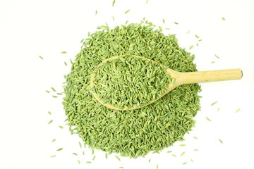 dried fennel seeds or Saunf herb in spoon isolated, top view 