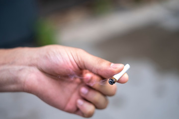 Person holding a lit joint