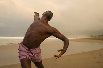contemporary dance choreographer and dancer doing ballet beach workout . a young attractive and...
