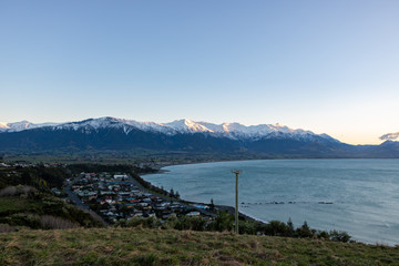 Sun rising over Kaikoura Mountains and Township in New Zealand 