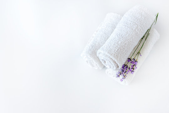 white clean towels and lavender flowers on white isolated background