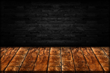 Empty wooden table isolated on black brick wall background
