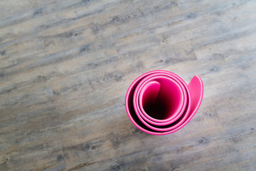Pink yoga mat is located inside the room.