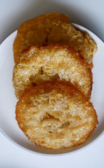 Bowsprit cake or kue cucur on white plate. Indonesian traditional cake.
