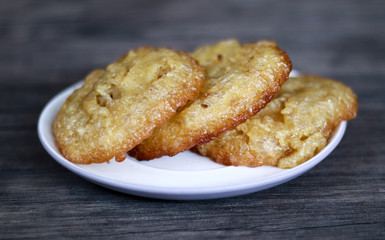 Bowsprit cake or kue cucur on wood background. Indonesian traditional cake.