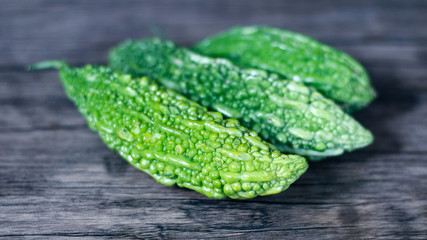 Bitter melon on wood background. Healthy food.  