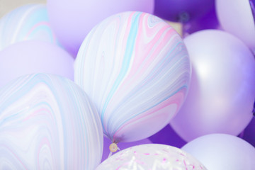 close up of lilac, purple and violet balloons while celebration. Birthday background with balloons.