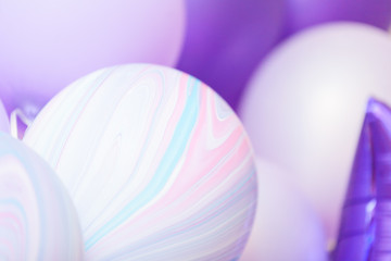 close up of lilac, purple and violet balloons while celebration. Birthday background with balloons.
