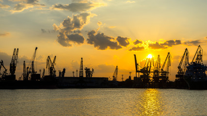 Fototapeta na wymiar Panoramic view toward sea port and industrial cranes
