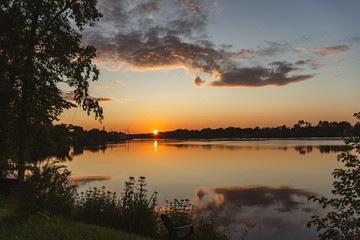 The orange light of a beautiful sunset is reflected in the eagle creek at Marinette,WI.