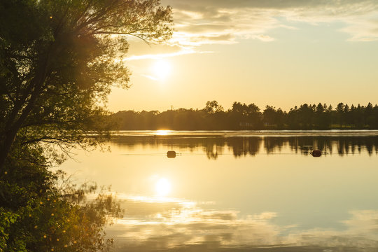 The orange light of a beautiful sunset is reflected in the eagle creek at Marinette,WI.