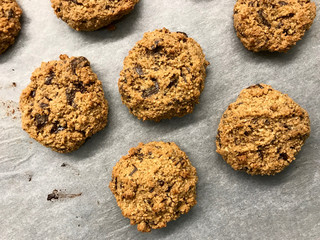 Paleo Chocolate Chip Cookies Made with Coconut and Almond Flour on Baking Paper.