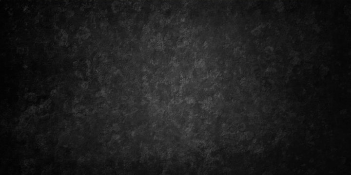 Black grunge texture on old background in distressed vintage design with a grungy rough surface in an elegant classy background with soft lit center and dark borders.