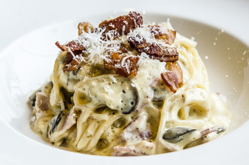 Carbonara pasta, spaghetti with pancetta, egg, hard parmesan cheese and cream sauce. Traditional italian cuisine. Pasta alla carbonara very delicious
