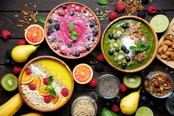 Smoothie bowls. Healthy breakfast bowl with chia seeds, muesli, berries, fruits and coconut flakes...