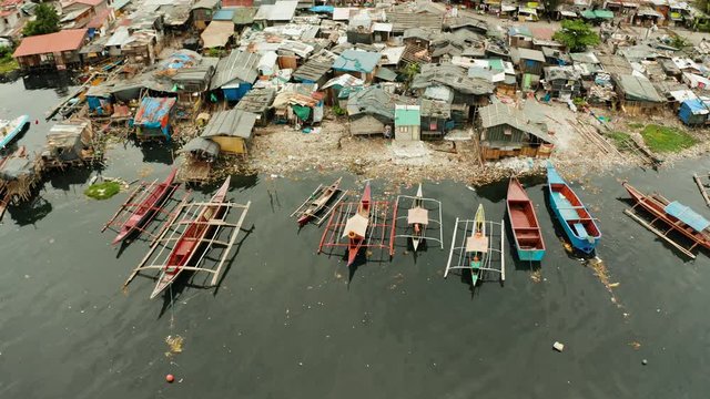 Slums in Manila near the port. River polluted with plastic and garbage. Manila, Philippines.