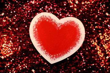 Fototapeta premium beautiful red heart on red shiny background