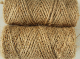 Ball of coarse thread brown background