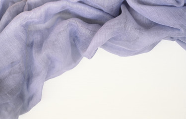 Violet chaotic draped fabric on corner of white wood
