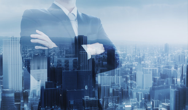 Businessman with arm crossed, double exposure futuristic city