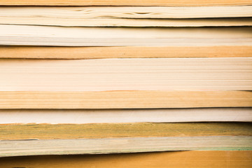Vintage books in stack. Library with many old books background. Horizontal shot