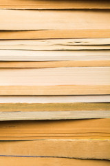 Vintage books in stack. Library with many old books background. Vertical shot