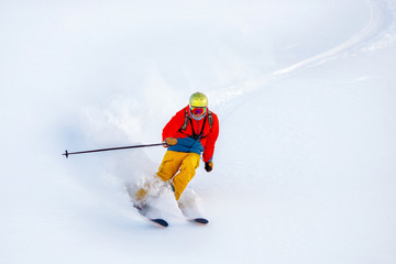 Skier on background bright white, fluffy snow