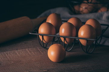 Fresh eggs in a basket on wooden table