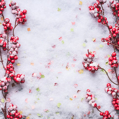 Red frozen berries on snow background. Winter and Christmas layout. Flat lay . Copy space