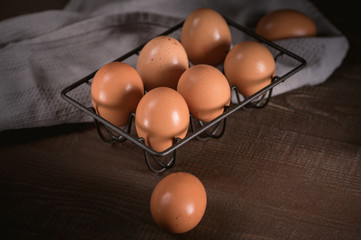 Fresh eggs in a basket on wooden table