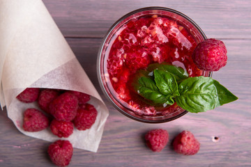 Glass of fresh strawberry smoothie and fresh strawberries on pink wooden background. Healthy food and drink concept.