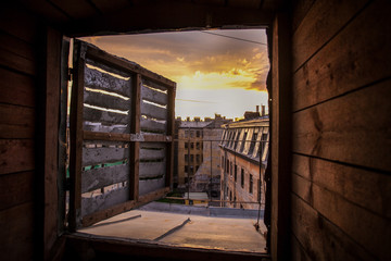 Unusual wonderful city sunset from the wooden window frame, St. Petersburg, Russia