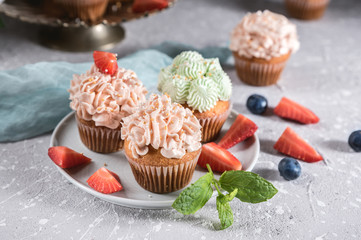Homemade tasty cupcakes with fresh berries