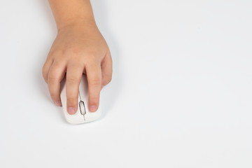 Top view of little Asian boy hand or elementary schoolkid hold mouse and keyboard with copy space on white table background