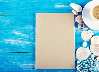 cup of coffee, shells, mobile phone on the old blue wooden boards.sea style. marine still life