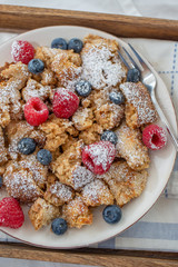 Kaiserschmarrn - traditional austrian pancake dessert with fresh fruit
